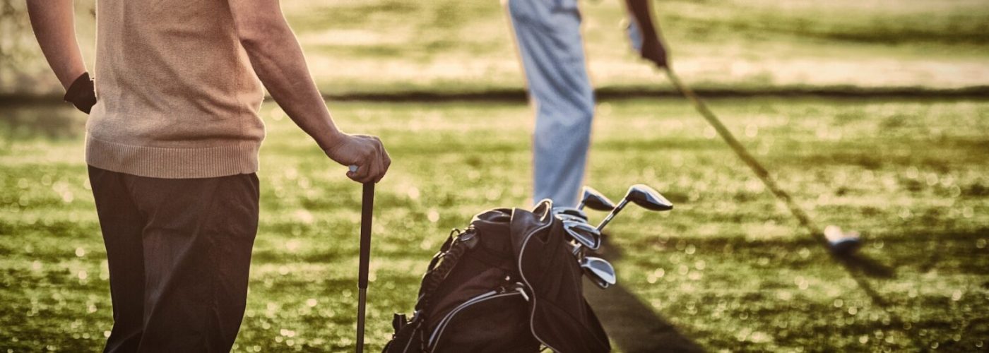 Mature golfer men standing on field